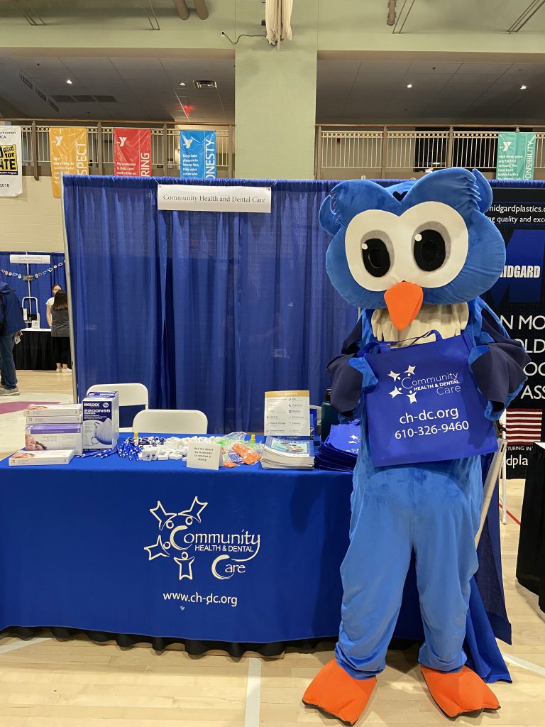 Dash handing out CHDC information, masks, and COVID-19 testing kits at the UPVCC Business Expo and Job Fair