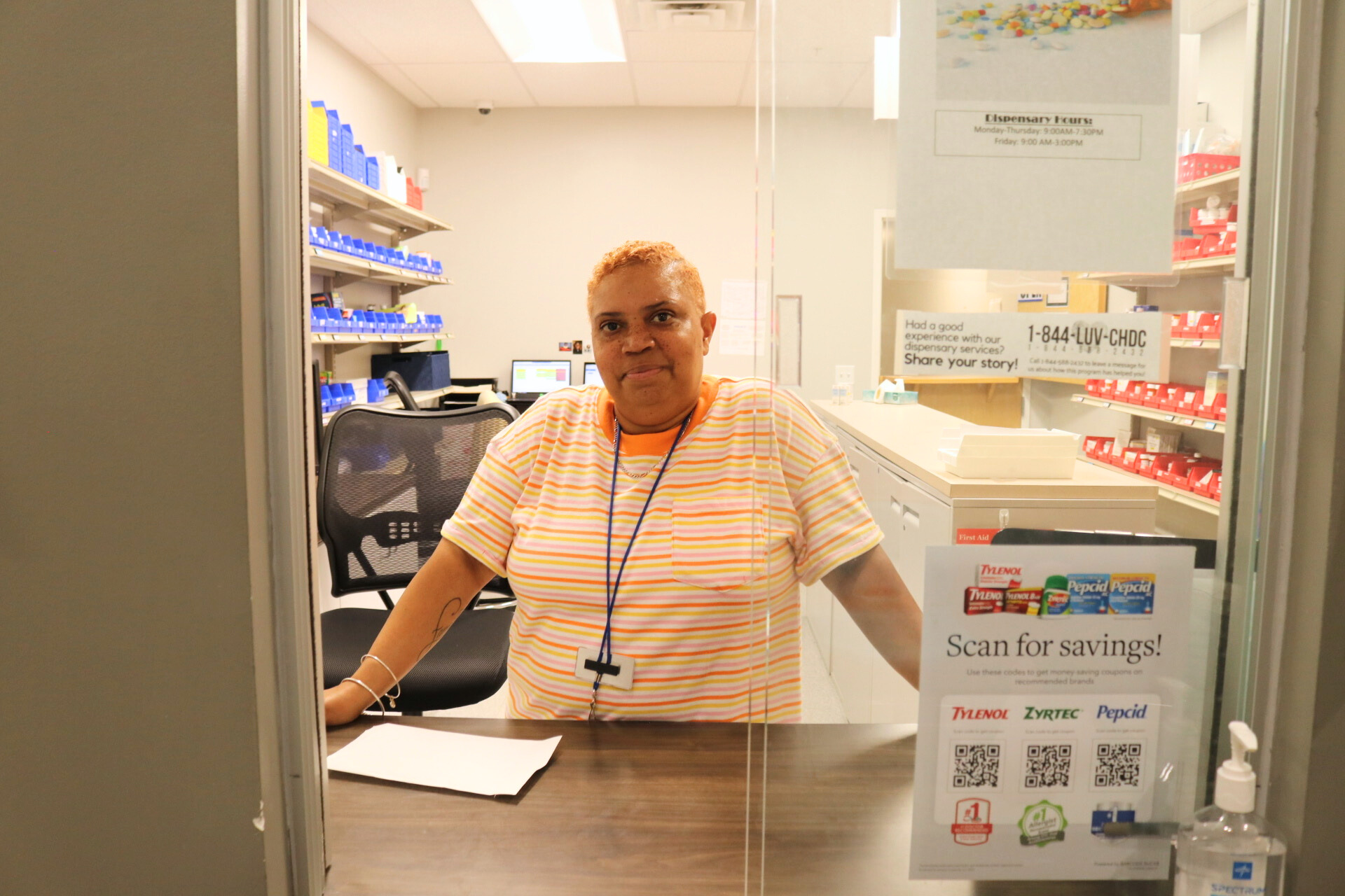 Dispensary provider Ranita smiling through the window of the dispensary.