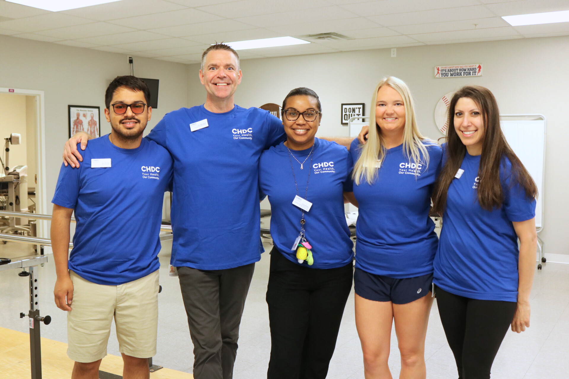 Physical Therapy providers posing for the camera in their blue CHDC t-shirts.