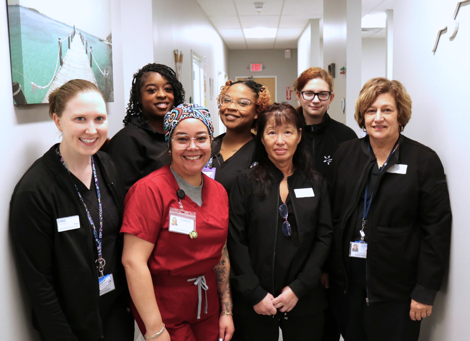 Dental hygiene team wearing scrubs and posing for photo