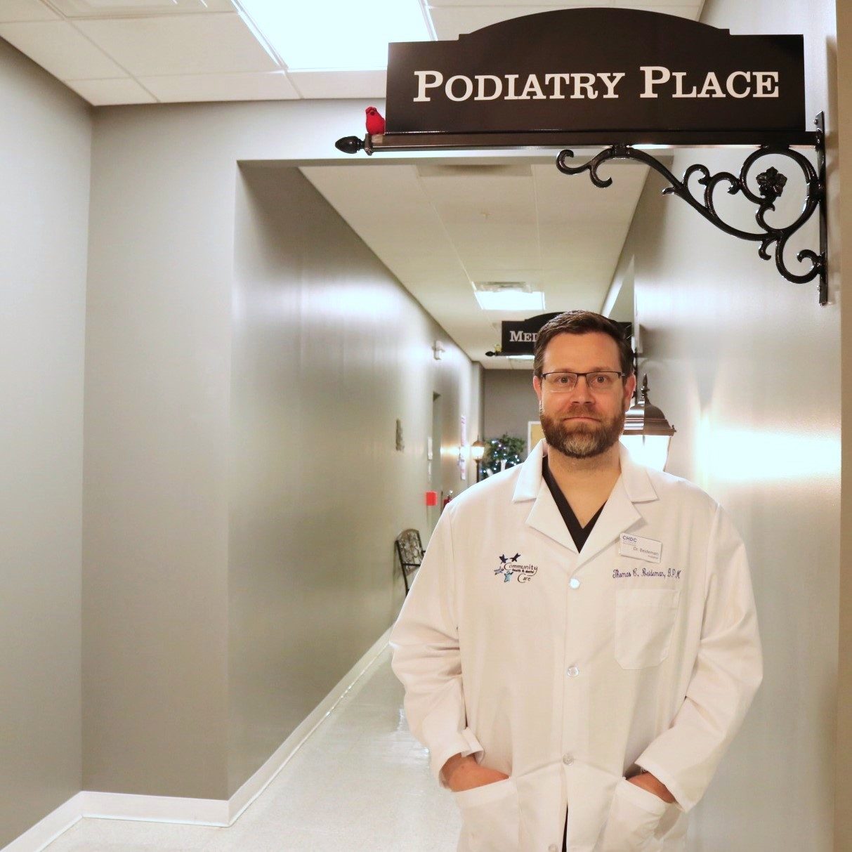 Dr. Beideman standing under Podiatry Place sign.